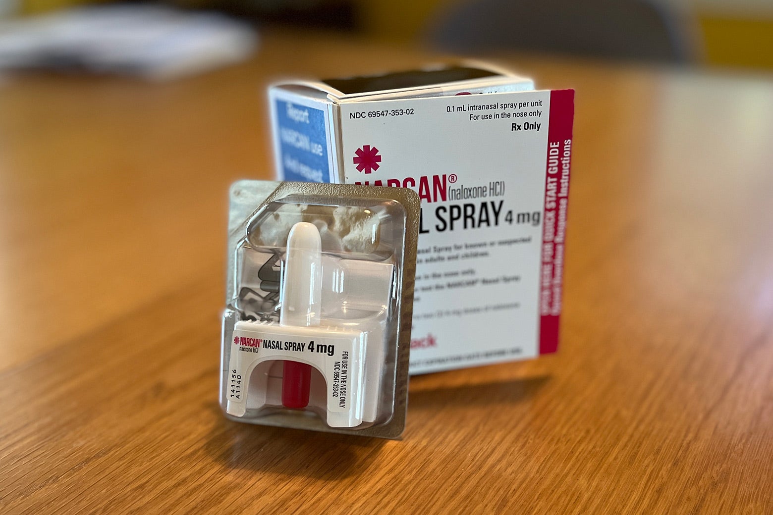 Narcan nasal spray in the packaging sitting on a tabletop.