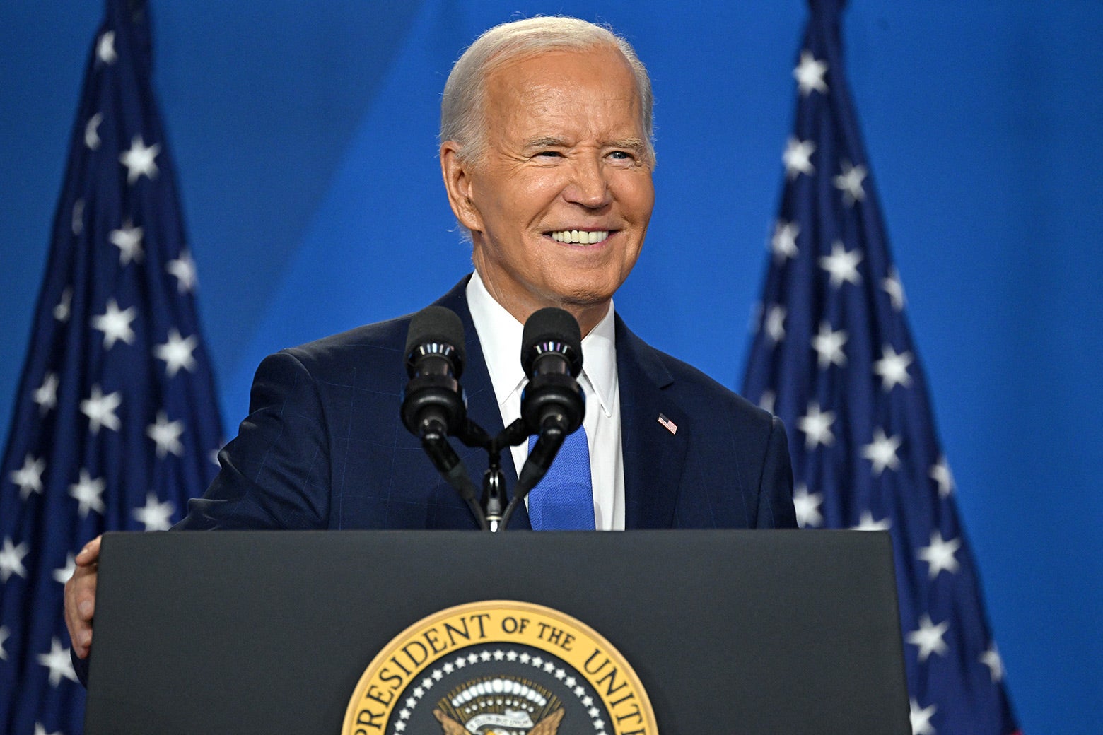 A man stands at a lectern.