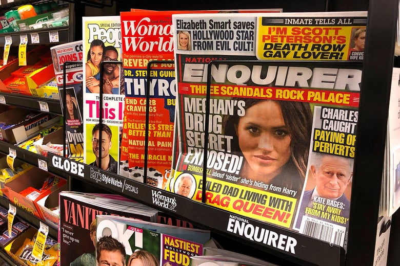 A copy of the National Enquirer in a grocery store checkout lane. One headline about Prince Charles reads "Paying off perverts."