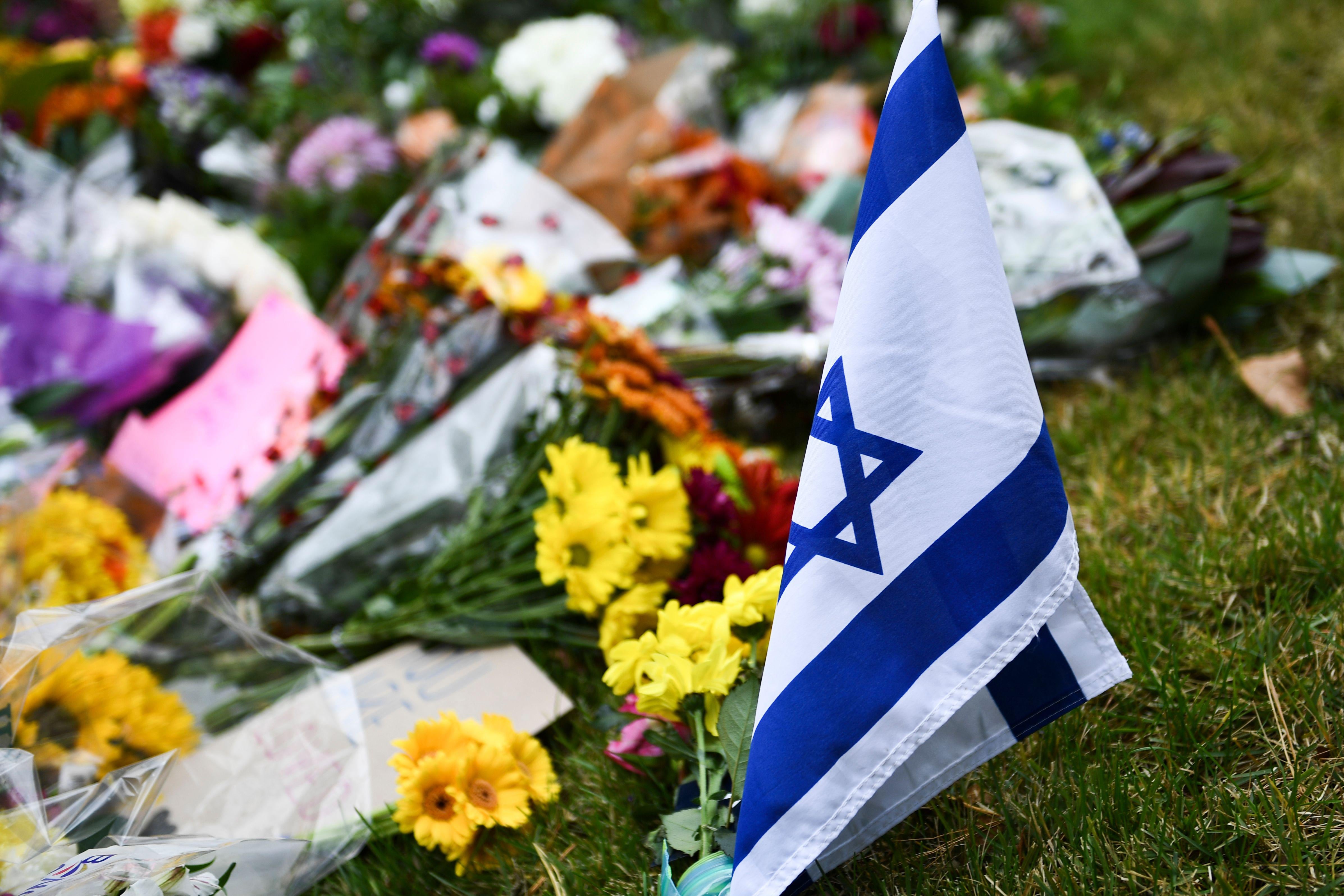 An Israeli national flag is seen at a memorial down the road from the Tree of Life synagogue.