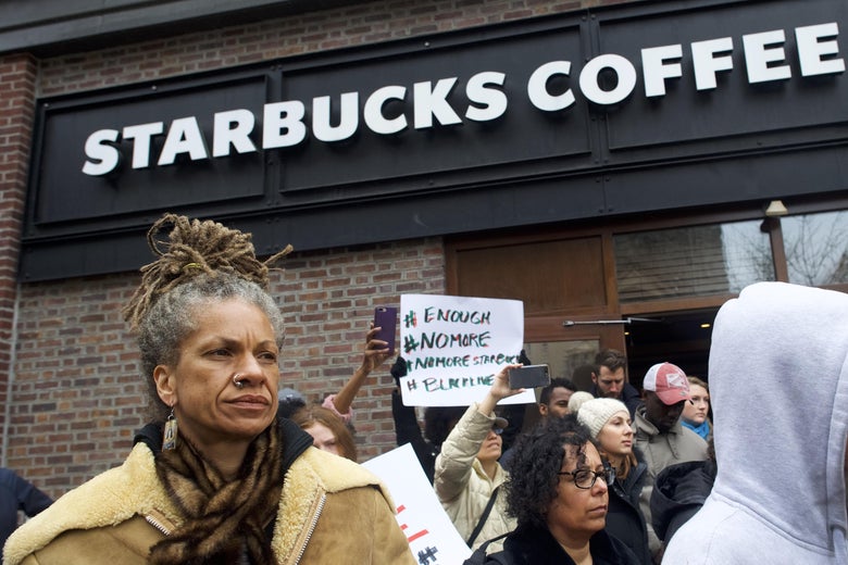 PHILADELPHIA, PA - APRIL 15:  Protestor Michelle Brown, 50, (L) demonstrates outside a Center City Starbucks on April 15, 2018 in Philadelphia, Pennsylvania. Police arrested two black men who were waiting inside the Center City Starbucks which prompted an apology from the company's CEO.  (Photo by Mark Makela/Getty Images)