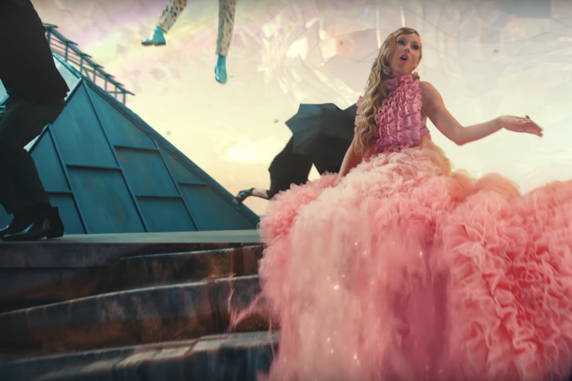 A frilly, fluffy Taylor Swift in a pink dress in the video for "ME!"