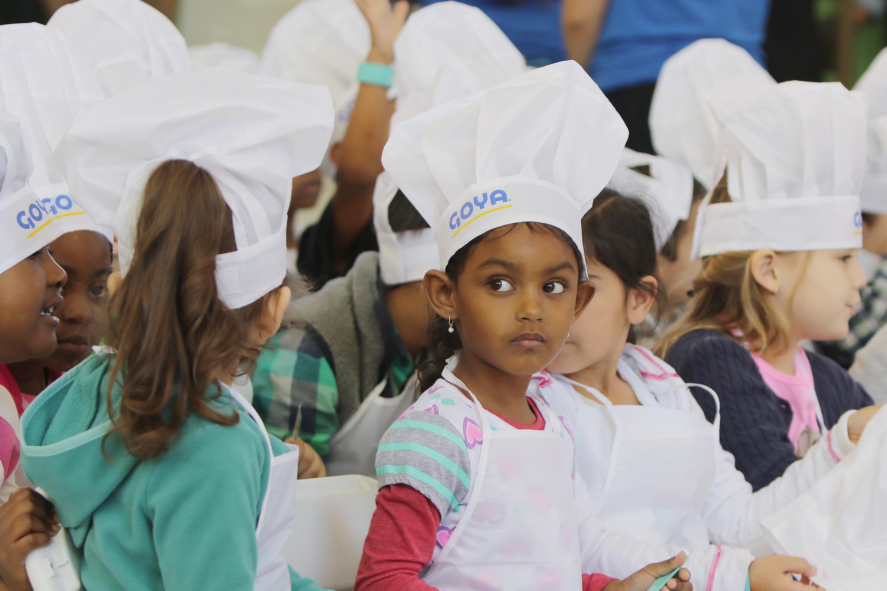 Children wearing chefs' hats.