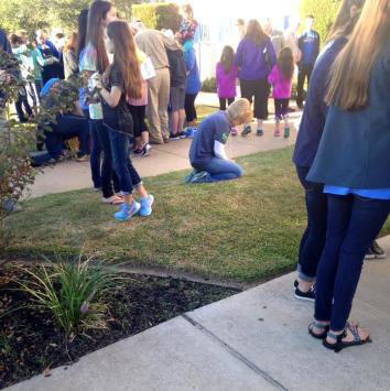 A student praying during a prayer rally.