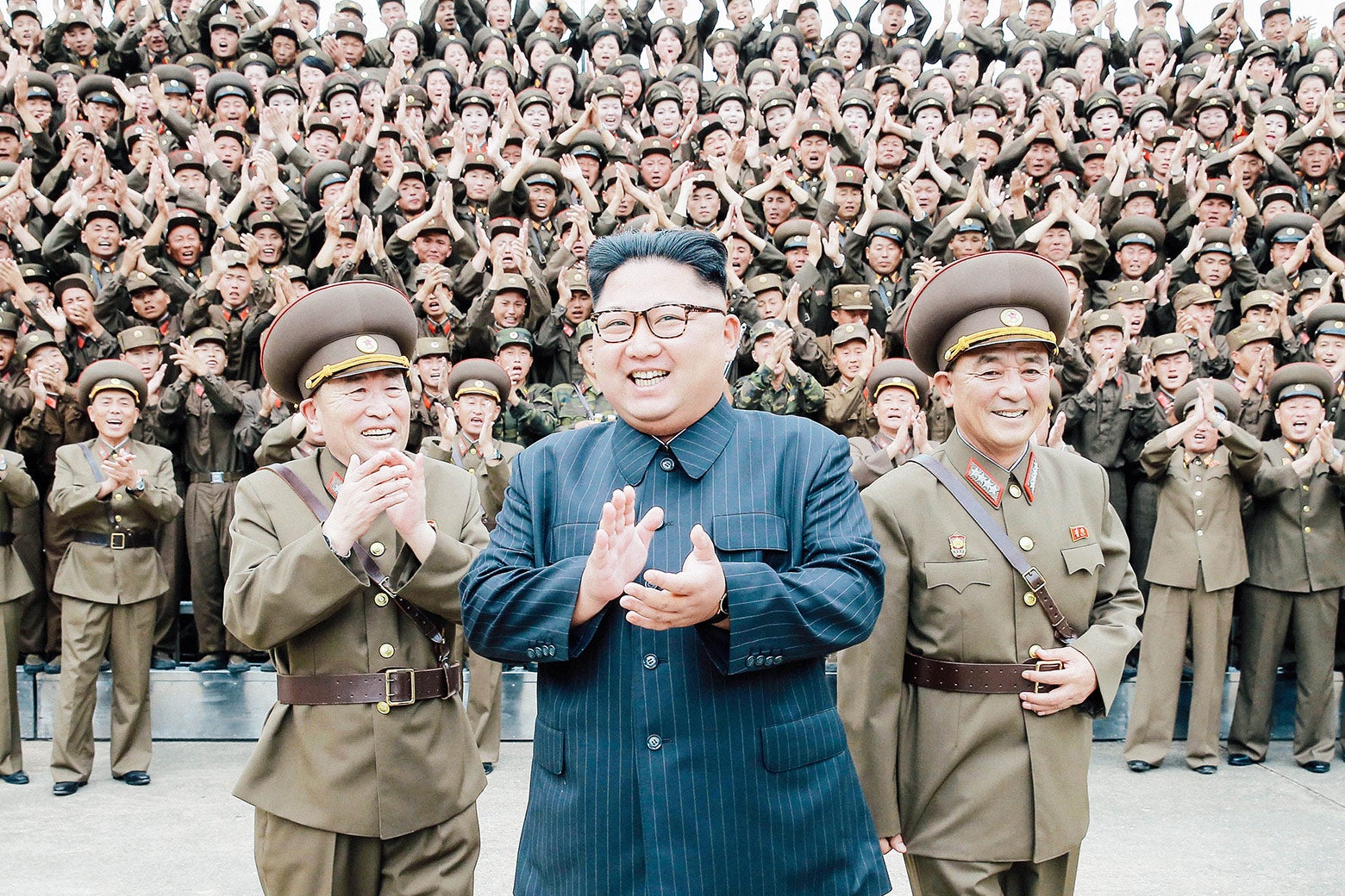 North Korean leader Kim Jong-un claps with military officers at the Strategic Force Command of the Korean People’s Army in an unknown location in North Korea in this undated photo released by the Korean Central News Agency on August 15.