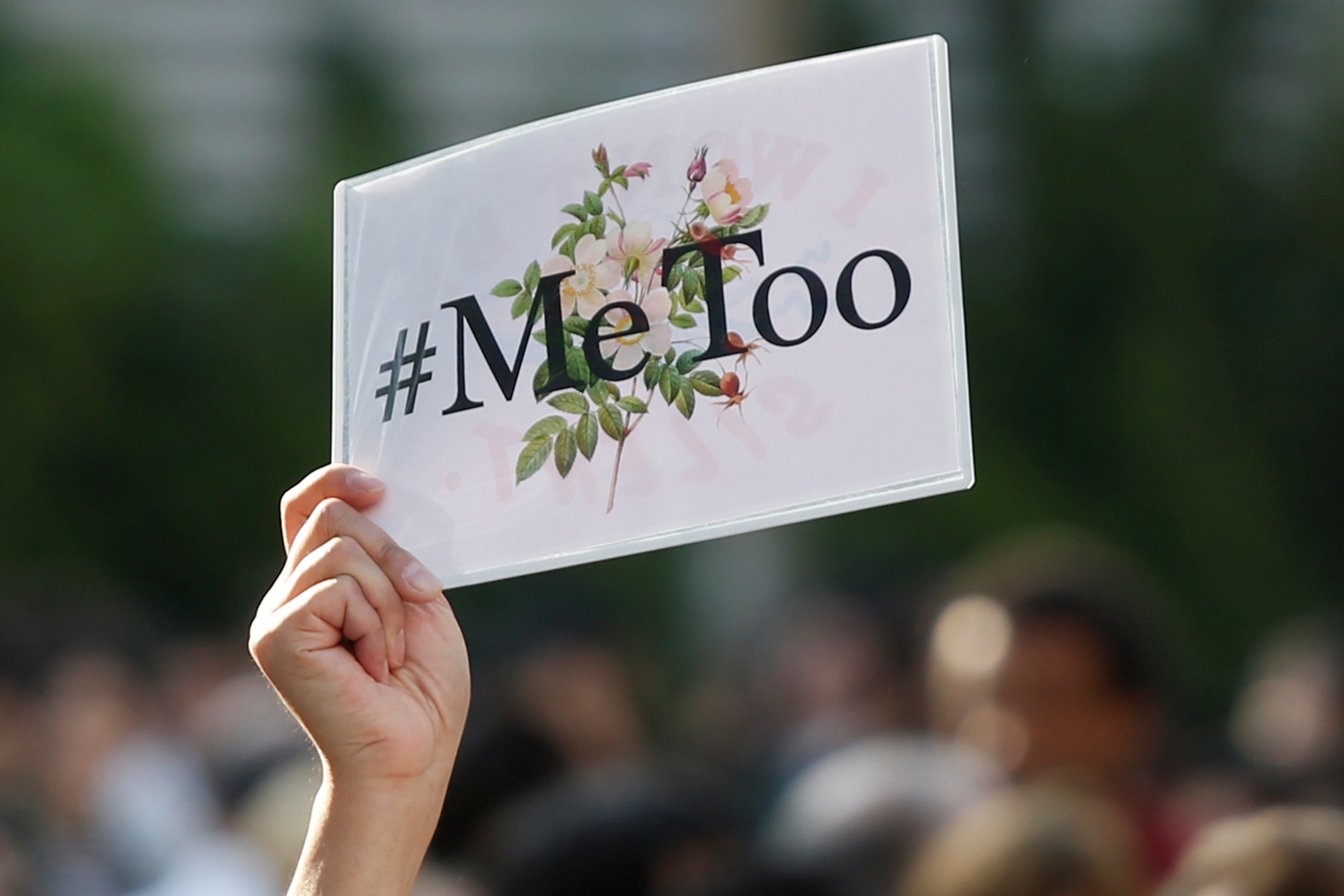 A protester raises a placard reading "#MeToo" during a rally in Tokyo.