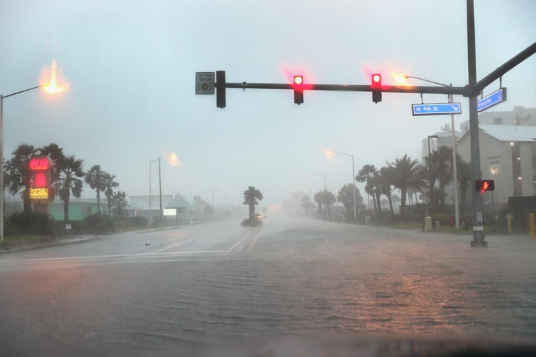Water floods a road as the outer bands of Hurricane Sally come ashore in Gulf Shores, Alabama.