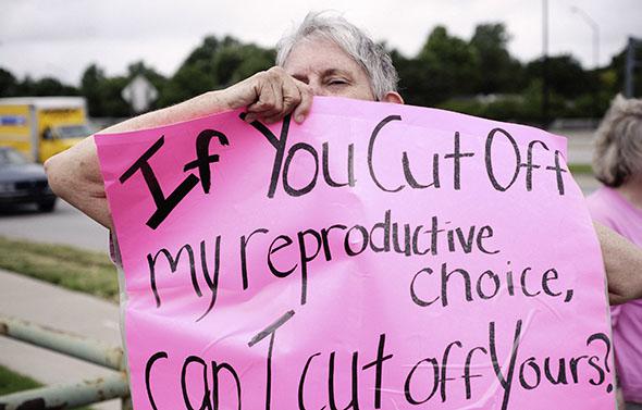 A pro-choice supporter demonstrates in front of the clinic of Dr. George Tiller, who was killed by anti-abortion activist, in Wichita, Kansas, in June 2009.