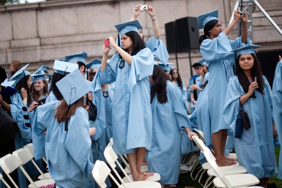 Graduates from Columbia University's School of Public Health take photos during the university's commencement ceremony in New York, May 16, 2012.