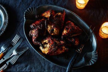 Dark-colored chicken in a dish.