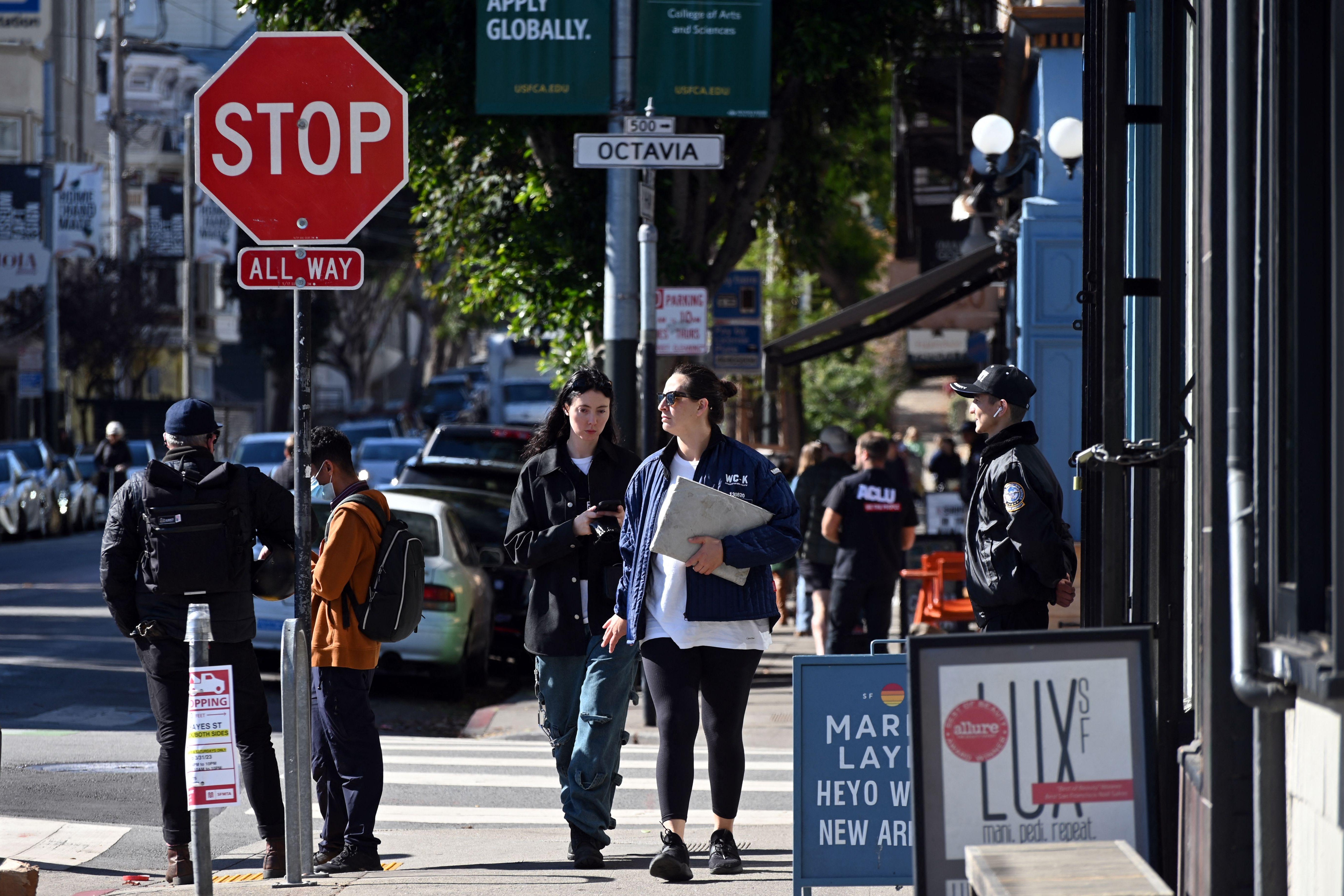 Pedestrians walk along Hayes Street in the Hayes Valley neighborhood San Francisco, California, on November 2, 2022. - When an upmarket clothing brand shuttered its San Francisco store last month, its boss said the west coast destination was a "city of chaos" where gangs of criminals roam free, robbing businesses at will.
The closure of Cotopaxi seemed to confirm everything the Republican Party has been saying about rising crime in the United States in the run up to the midterm elections. (Photo by Samantha LAUREY / AFP) (Photo by SAMANTHA LAUREY/AFP via Getty Images)