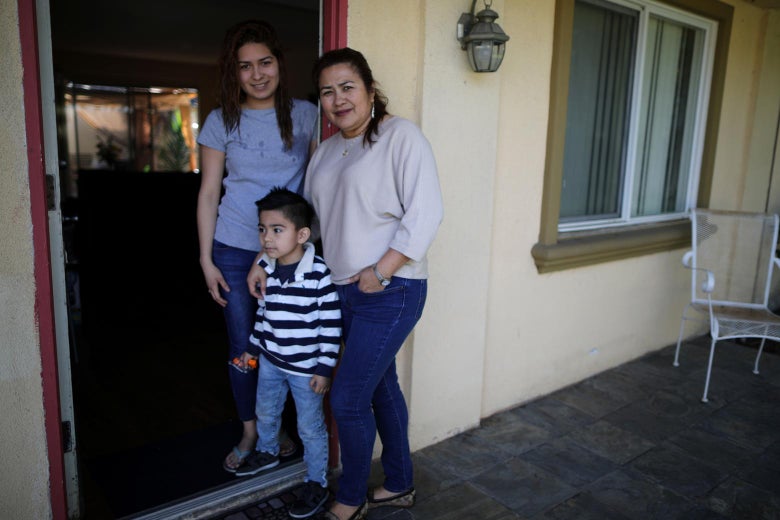 Salvadoran immigrant Isabel Barrera poses with her daughter, Andrea Barrera, who has Central American Minors legal status, and her grandson, Matteo Menjivar, outside their home in Anaheim, California.