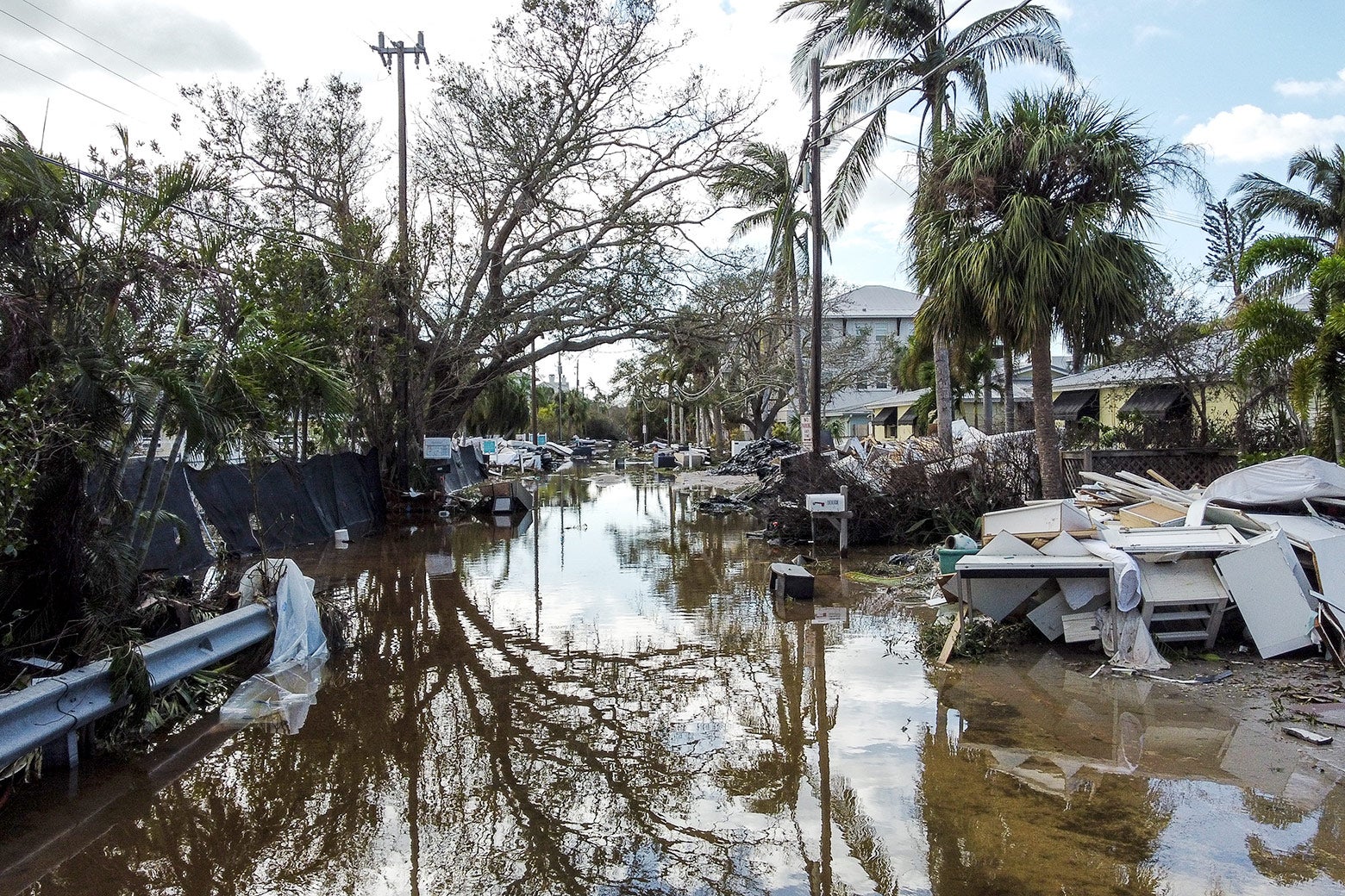 A flooded street littered with debris.