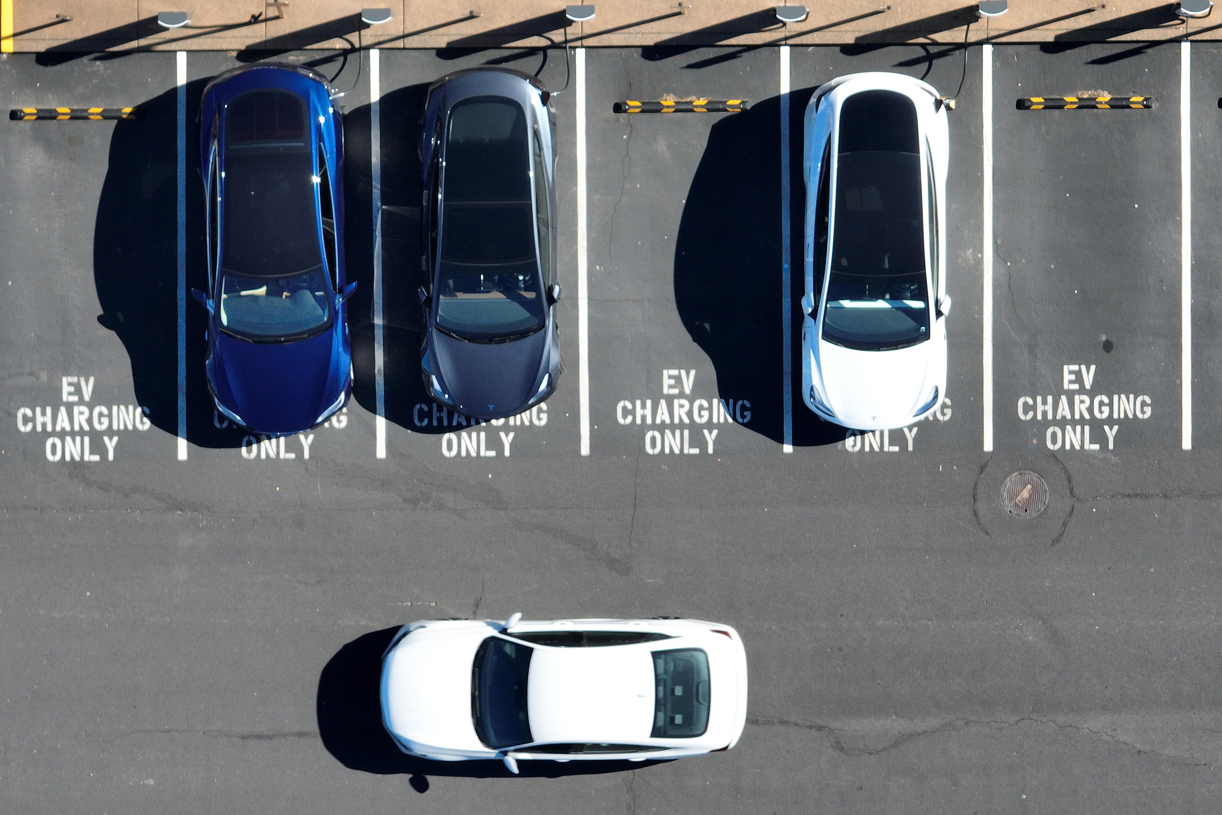 In an aerial view, Tesla cars recharge at a Tesla charger station on February 15, 2023 in Corte Madera, California. Electric car company Tesla is partnering with the U.S. federal government to expand electric vehicle charging infrastructure in the United States. Tesla announced plans to open an estimated 7,500 of its Tesla Superchargers in the country to all brands of electric vehicles by the end of 2024. (Photo by Justin Sullivan/Getty Images)