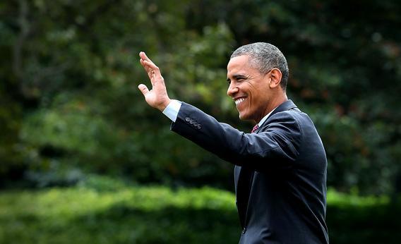 U.S. President Barack Obama waves as he walks toward Marine One while departing the White House.