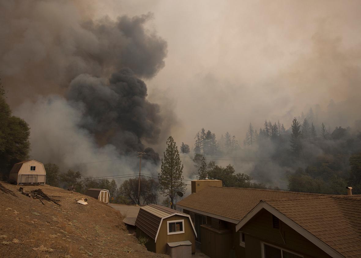Smoke rises near a house on Mountain Ranch Road at the Butte Fire on September 13, 2015 near San Andreas, California.