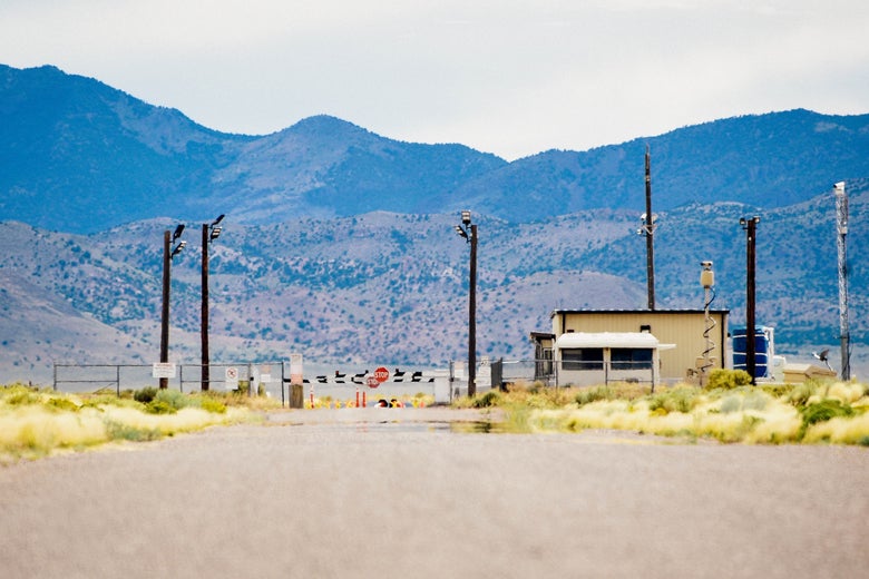 A gate to a military base amid the mountains and desert.