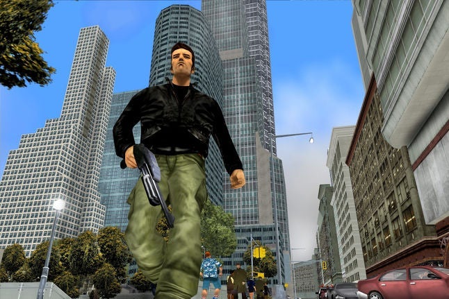 A man in a black jacket and green pants walks down a city block while holding a gun.