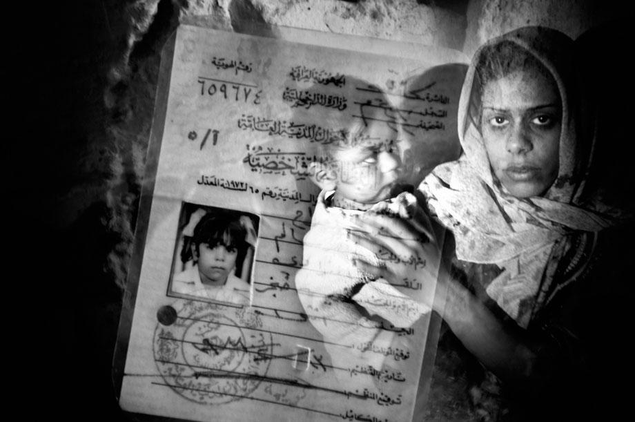 Afra'ah Nasir Salem al Azawii, Sunni, stands for a portrait in the Adhamiyah neighborhood of Baghdad, Iraq on Jan. 22, 2007. She feels safe living in the Sunni stronghold of Adhamiyah even though she has to wear a veil when she leaves her home. Al Qaeda and other Islamic militias control the area therefore rigid Islamic rules are in place. The invasion of Iraq broke a community into sectarian halves, at each other?s throats: Sunni and Shiite, who have lived together -- albeit not in perfect harmony -- for 1400 years became mortal enemies, killing each other?s women and children.