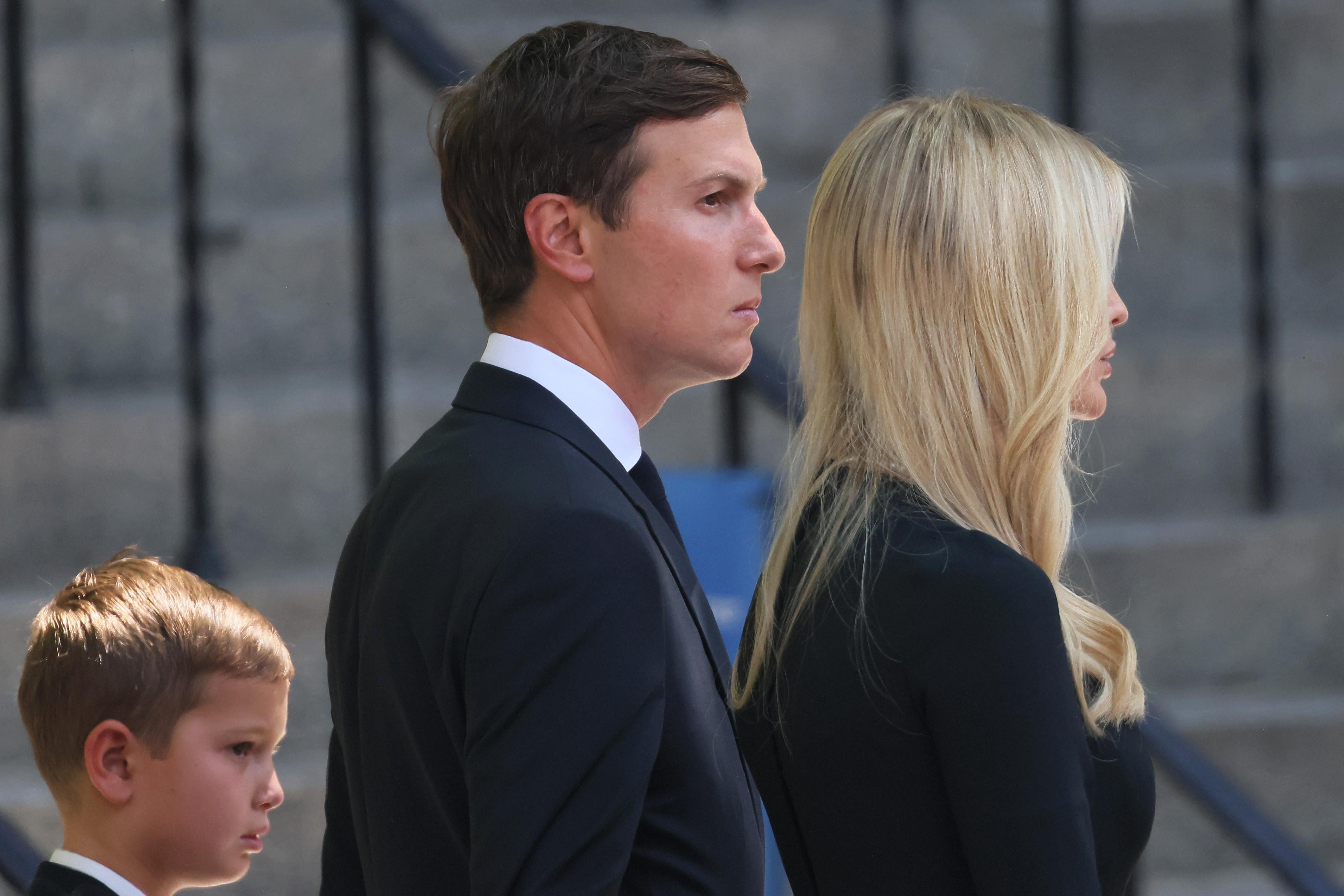 Kushner stares into the distance, standing by Ivanka.