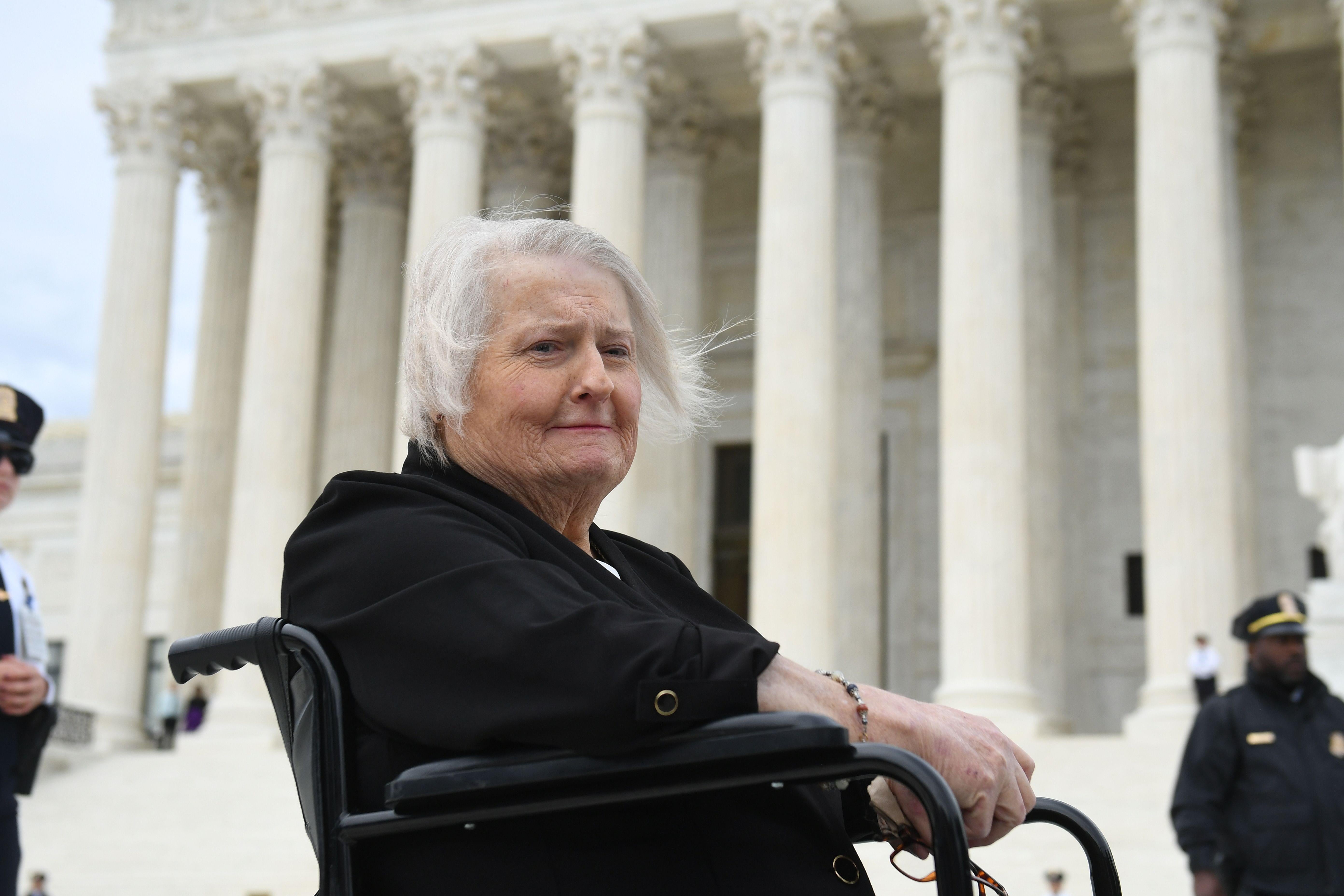 Transgender activist Aimee Stephens sits in her wheelchair outside the U.S. Supreme Court building.