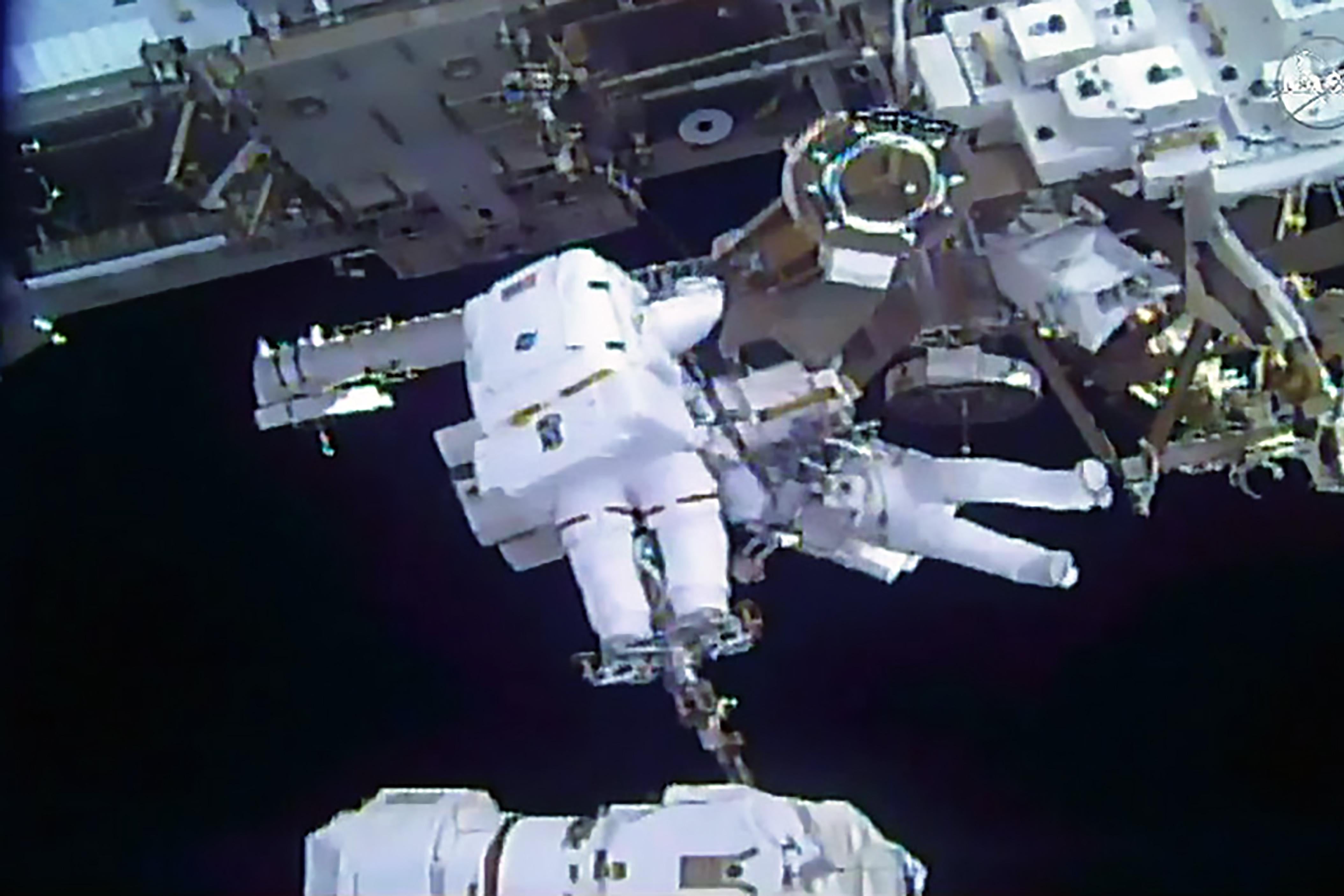 This still image from video courtesy of NASA shows spacewalkers Mark Vande Hei of the US (foreground) and Norishige Kanai of Japan transferring a spare robotic hand to a long-term stowage area on the International Space Station, February 16, 2018.  
A Japanese and an American astronaut floated for hours outside the International Space Station on a spacewalk to repair the orbiting outpost's robotic arm and move some equipment into storage. The spacewalk, broadcast live on NASA TV, was the first for Japanese Aerospace Agency (JAXA) astronaut Norishige Kanai, and the fourth for his US counterpart Mark Vande Hei.  / AFP PHOTO / AFP PHOTO AND NASA / NASA        (Photo credit should read NASA/AFP/Getty Images)