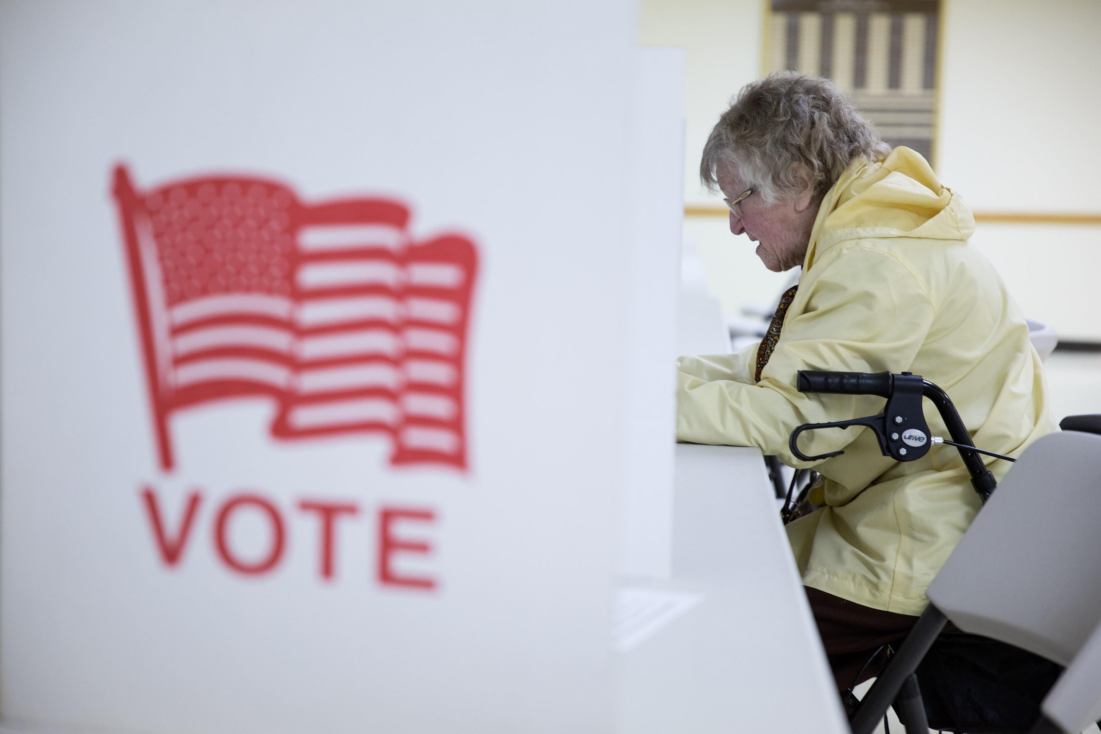 A voter fills out her ballot in New Hampshire.