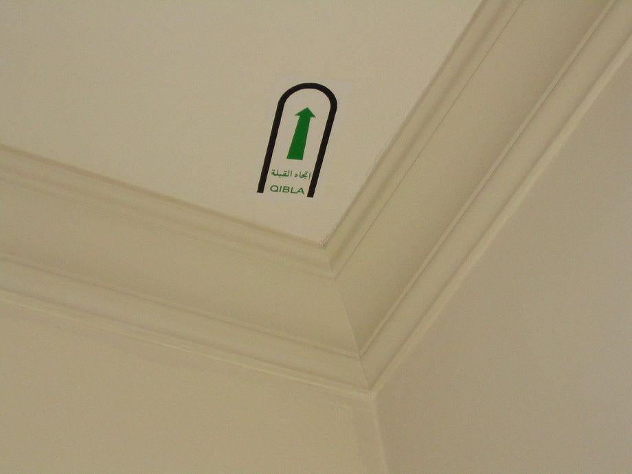 The arrow on a hotel room ceiling or desk is the Qibla, an orientation
