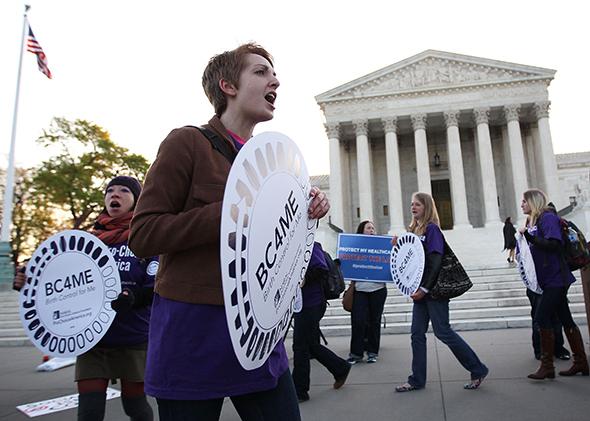 Pro-Obamacare supporters shout slogans in front of the U.S. Supreme Court on March 27, 2012 in Washington, D.C.