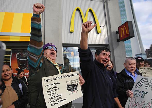 Activists chant for higher wages outside a McDonald's.
