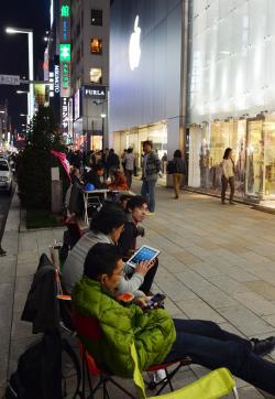 The Apple Army awaits their iPistols outside the Apple Store in Tokyo