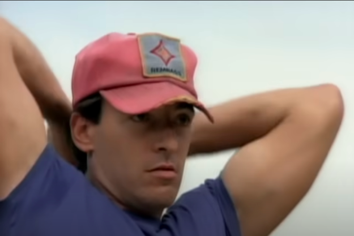Springsteen's face is determined, his arms held high, his baseball cap badly creased