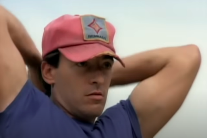 Springsteen's face is determined, his arms held high, his baseball cap badly creased