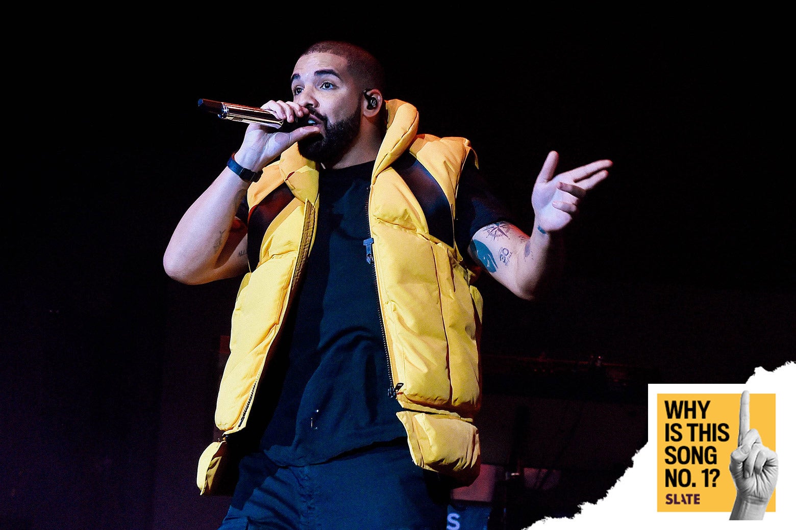 Drake, wearing a puffy vest, obviously