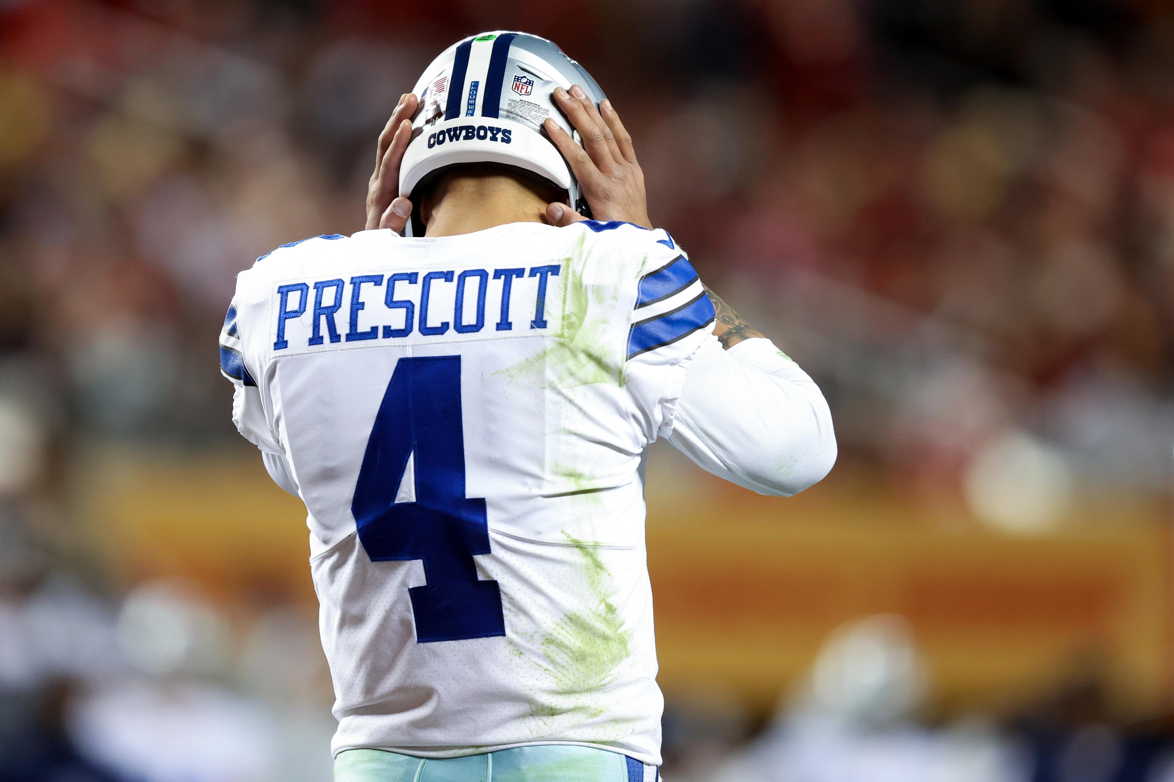 Prescott from behind puts his hands on the side of his head in frustration