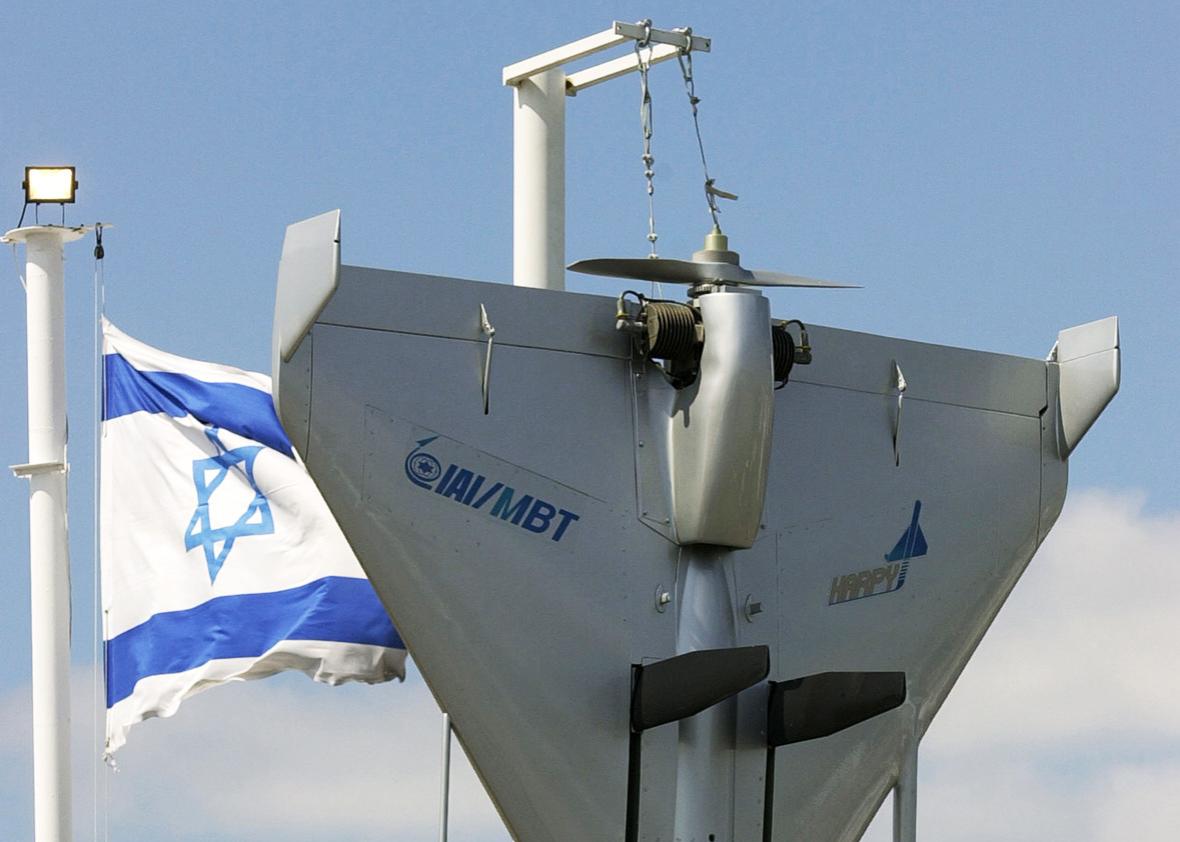 An Israeli flag flutters next to an Harpy IAI-MBT Attack Drone as part of the Israeli display during the 44th Paris Air Show at Le Bourget Airport, north of Paris, France, June 21, 2001. 