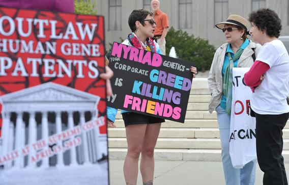 Protesters hold banners demanding a ban over human gene patents during a protest outside the Supreme Court in Washington on April 15, 2013.