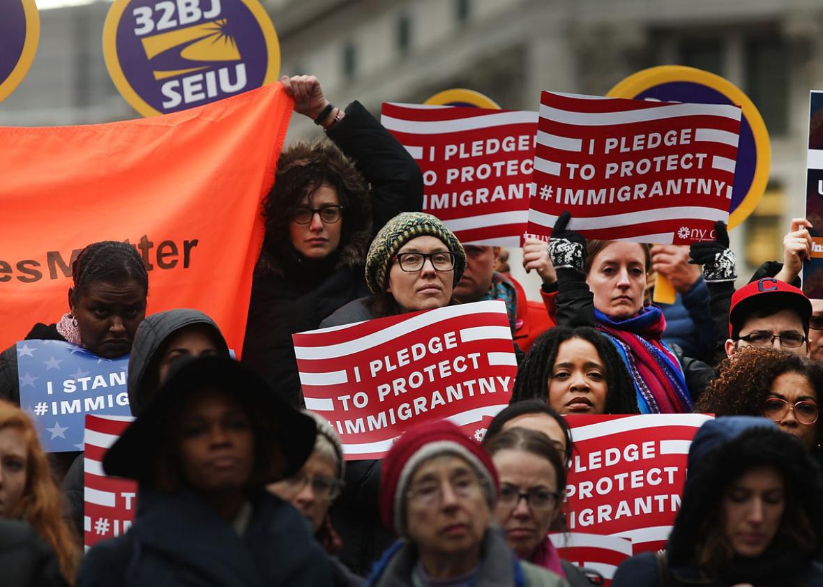 Area Muslims and local immigration activists participate in a prayer and rally against President Donald Trump's immigration policies.