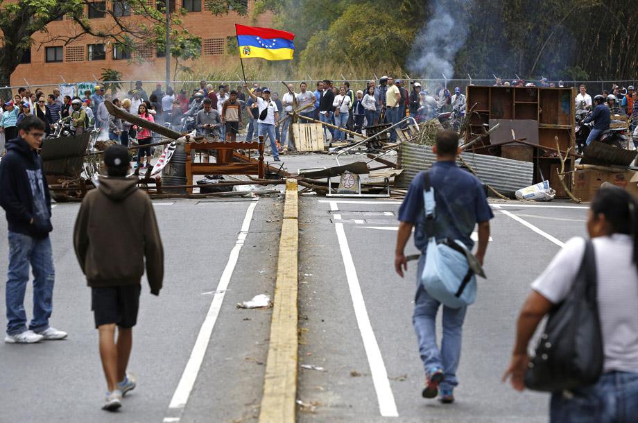Supporters of opposition leader Leopoldo Lopez stand at a barricade during a protest against Nicolas Maduro's government in a middle-class neighborhood in Caracas February 20, 2014.