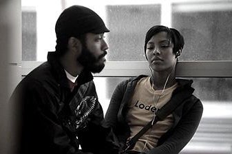 A man and a woman speak to each other in a black and white still from Medicine for Melancholy.