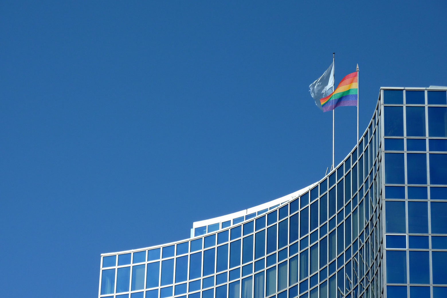 The U.N. headquarters with a pride flag flying atop it.