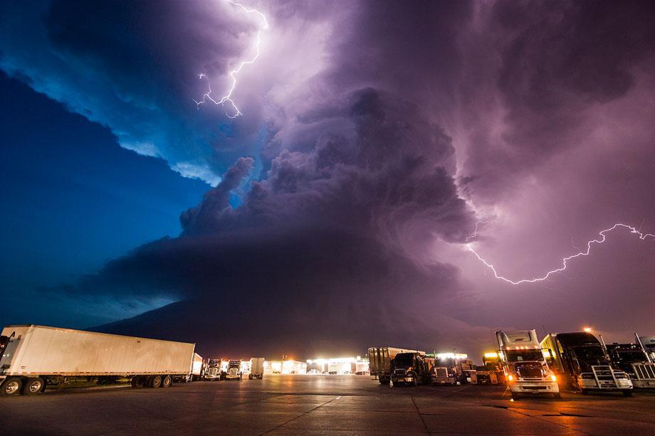 A supercell storm during twilight nears a York, Neb., truck stop on I80 as it spits out lightning, June 17, 2009.