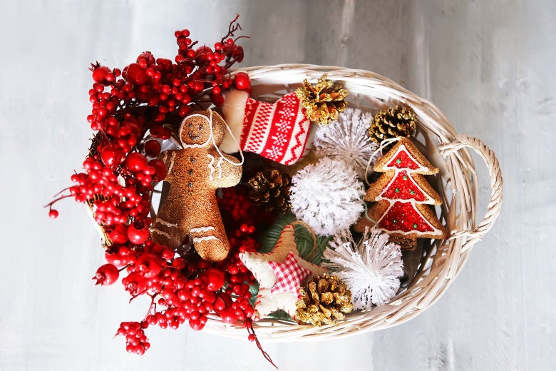 Festive basket of holiday goodies including golden pinecones, a gingerbread man, and a Christmas tree cookie