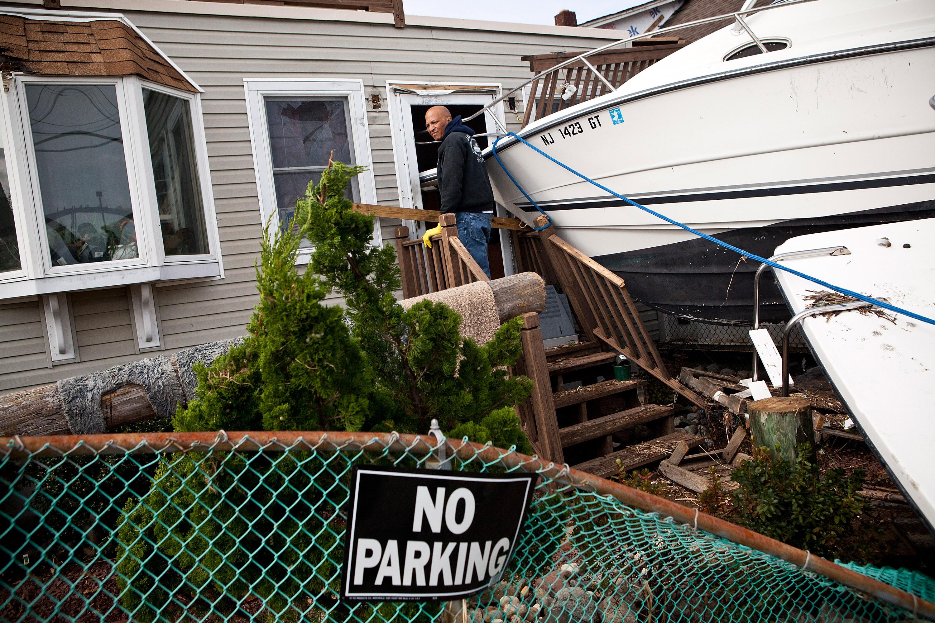 Clifford Seay helps his girlfriend, Regina Yahara-Splain, clean out her home, which was damaged by Superstorm Sandy, on November 1, 2012 in Highlands, New Jersey.