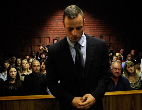Oscar Pistorius stands in the dock ahead of court proceedings at the Pretoria magistrates court February 22, 2013.