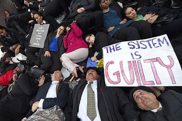 die-in to protest police brutality and the decisions by grand juries in New York and Missouri not to indict police officers involved in the deaths of Eric Garner and Michael Brown.