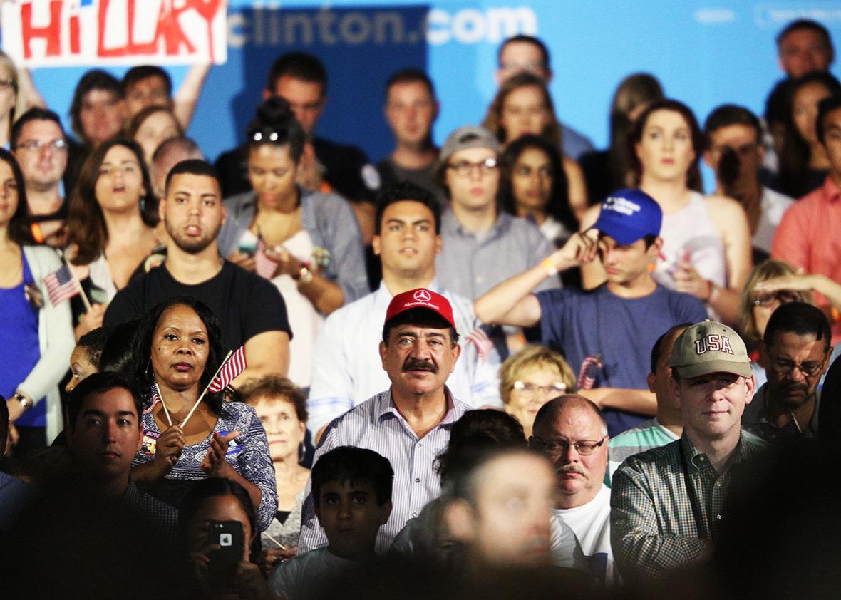 A man identified as Seddique Mateen, whose son shot and killed 49 people and injured 53 others inside the Pulse nightclub in June, sits with supporters at a rally for Democratic Presidential nominee Hillary Clinton at the Osceola Heritage Park in Kissimmee, Florida on August 8, 2016.