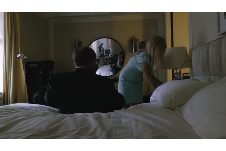A shot from Borat showing a startled Rudy Giuliani sitting up on a hotel bed.