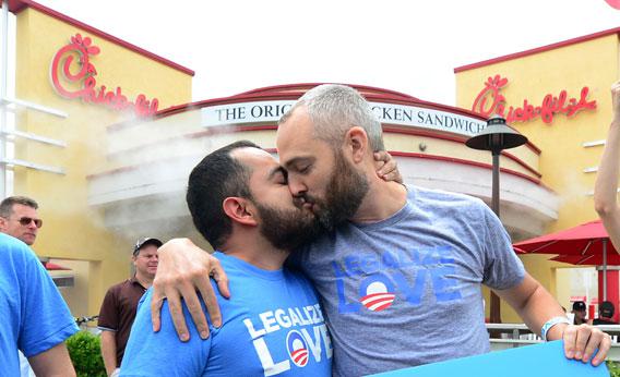 Eduardo Cisneros (L) and Luke Montgomery (R) kiss in front of a Chick-fil-A fast-food restaurant in Hollywood on August 3, 2012. 