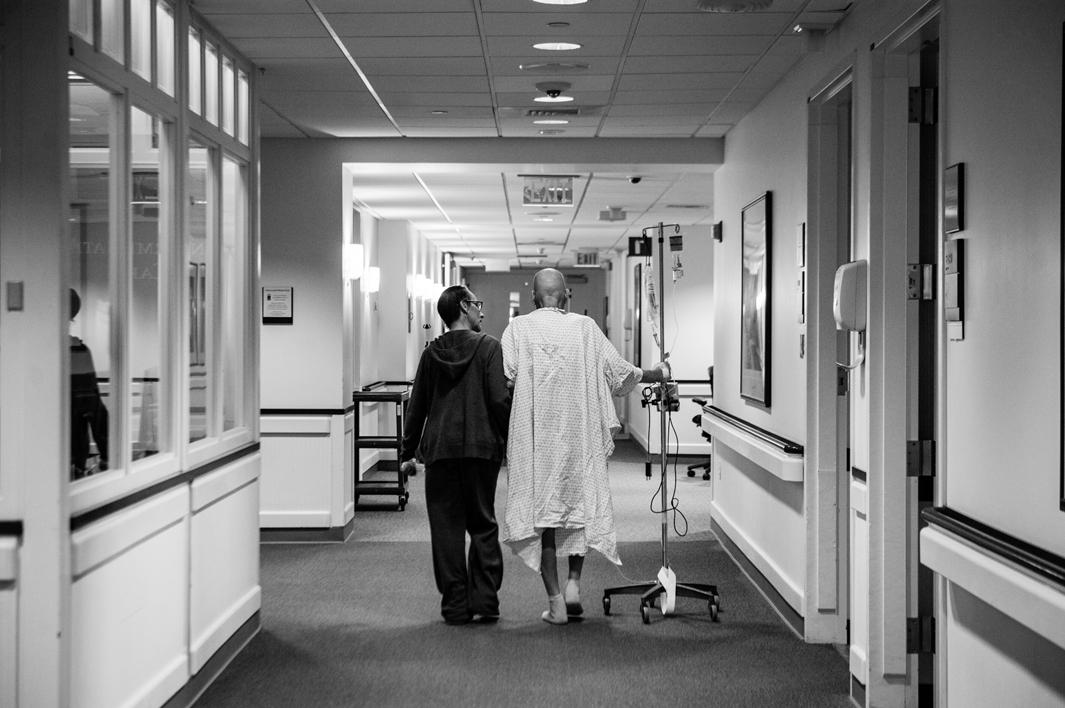 Recovering from a collapsed lung and managing a recent pneumonia diagnosis, Howard Borowick takes a walk down the hallways of Medical Oncology with the assistance of wife, Laurel Borowick, left, by his side. Greenwich, Connecticut. November, 2013.